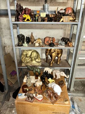 a shelf with many different types of figurines on it