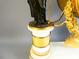a statue of a woman holding a staff on a pedestal
