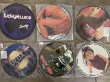 six cd ' s in plastic bags sitting on a counter top