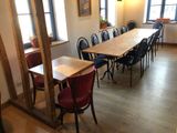 a long table with chairs and a vase on the table