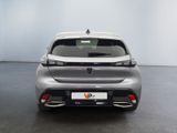 the rear end of a silver car in a white room