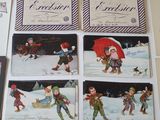 many cards of children playing in the snow with a red umbrella