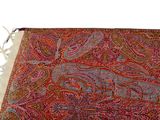 an image of a red and blue paisley scarf with fringes on a white background