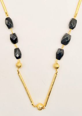 a gold necklace with black beads and a gold chain