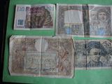 some old paper money sitting on top of a green table