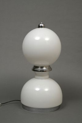 a white lamp that is sitting on a table
