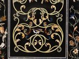 a picture of a black and gold rug with birds and flowers on it