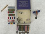 a small tin of medals and a pair of scissors in it
