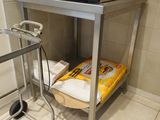 a microwave sitting on top of a cart in a kitchen