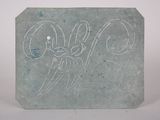 a stone with a drawing on it sitting on a table