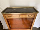 a wooden cabinet with a marble top on it
