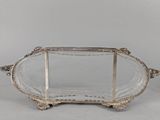an antique silver plate with a glass tray on it
