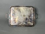 a silver tray with a handle on a table