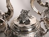 a silver tea pot and a silver tea pot on a table
