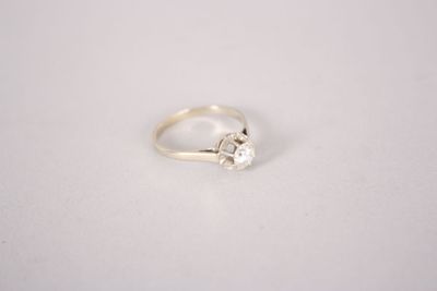 a close up of a white gold ring with a single diamond