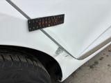 a close up of a sticker on the side of a white car