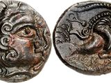 a silver coin with an image of a woman and a dragon on it