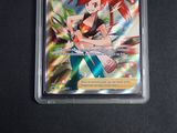 an image of a pokemon card with a girl holding a sword