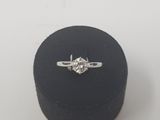 a close up of a diamond ring on a black ring box