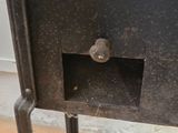 a black metal cabinet with a door and a knob on it