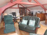 an image of a living room with a couch and two chairs
