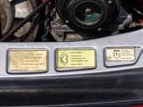 a close up of a car engine with its hood open