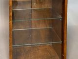 wooden display case with glass shelves and shelves on the sides