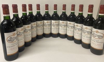 six bottles of wine are lined up in a row on a table