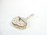 a small box with a spoon sitting on top of it
