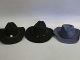 three hats are lined up in a row on a white surface