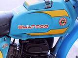 a blue and yellow motorcycle parked on the side of the street