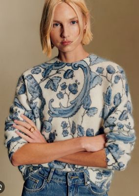 an image of a woman in a sweater and jeans
