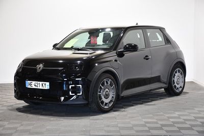 La voiture noire est garée sur le sol à damier de la pièce.