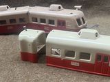 two toy trains sitting on the floor next to each other