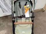 a baby stroller with a baby seat in the middle of it