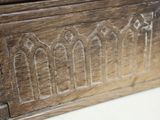 a close up of a wooden box with carvings on it