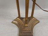 an antique brass table lamp with a marble top and a brass base