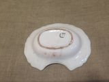 a white bowl with a brown rim sitting on a table