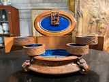 a wooden box with a blue velvet inside on a table