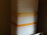 a stack of plastic plates sitting on top of a table
