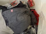 a pile of clothes and other items in a plastic bag