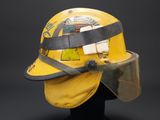 yellow fireman ' s helmet with protective face shield and visor