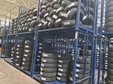 many tires stacked on a rack in a warehouse