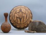 two vases and a bowl sitting on a table