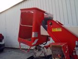 a red crane that is parked in front of a building