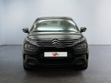 the front of a black citrole parked in a white room