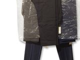 two pants hanging on a clothes rack on a wall