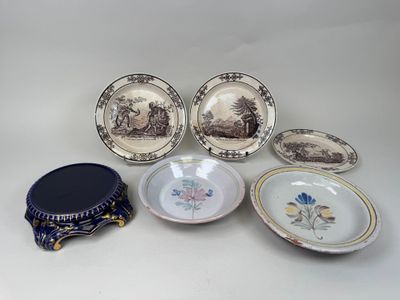 several plates and bowls are sitting on a white surface
