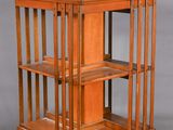 pair of antique wooden display cases with glass shelves on casteors