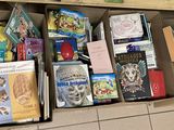 many books in a box on the floor